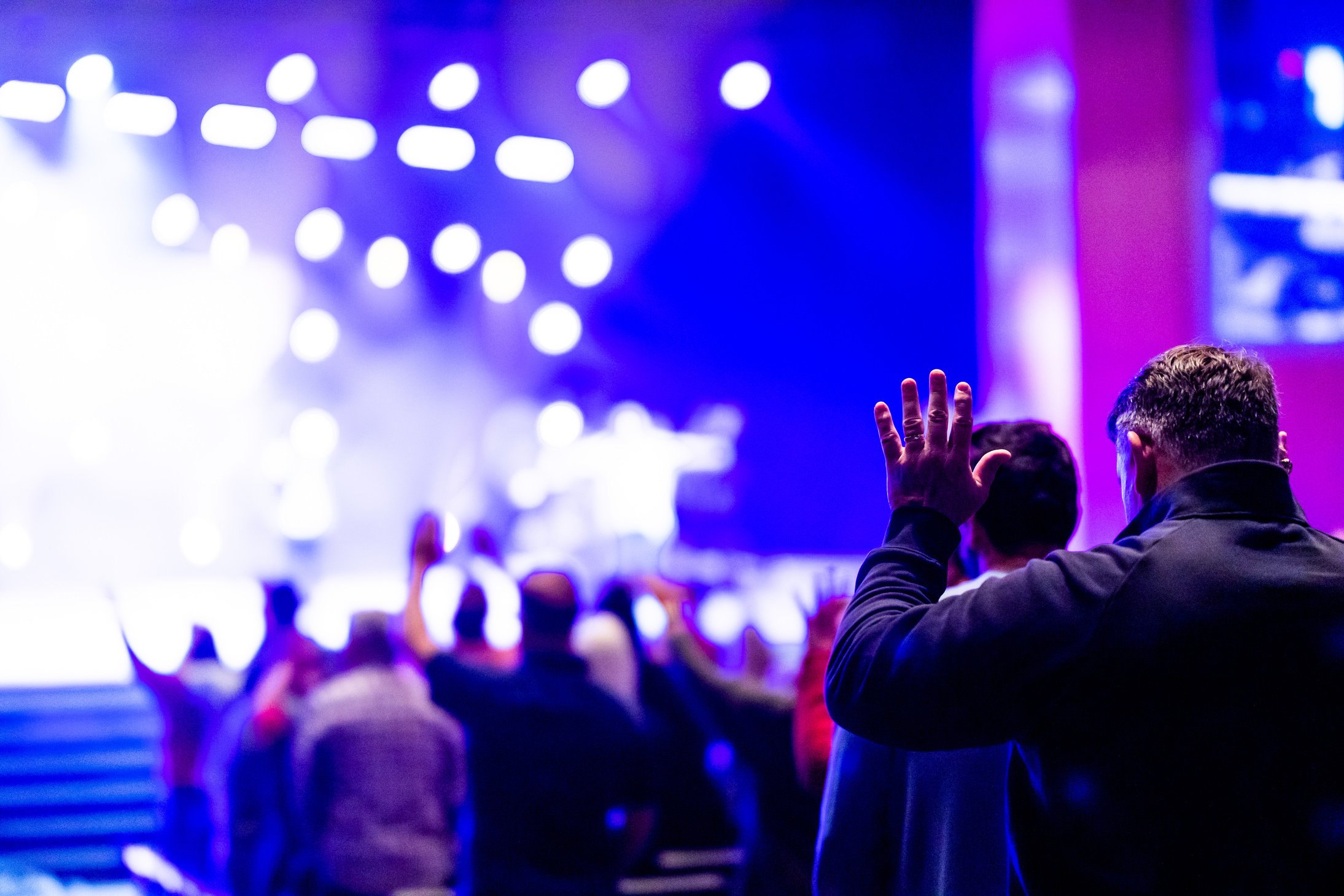 A Gathering of People raising their Hands in Prayer